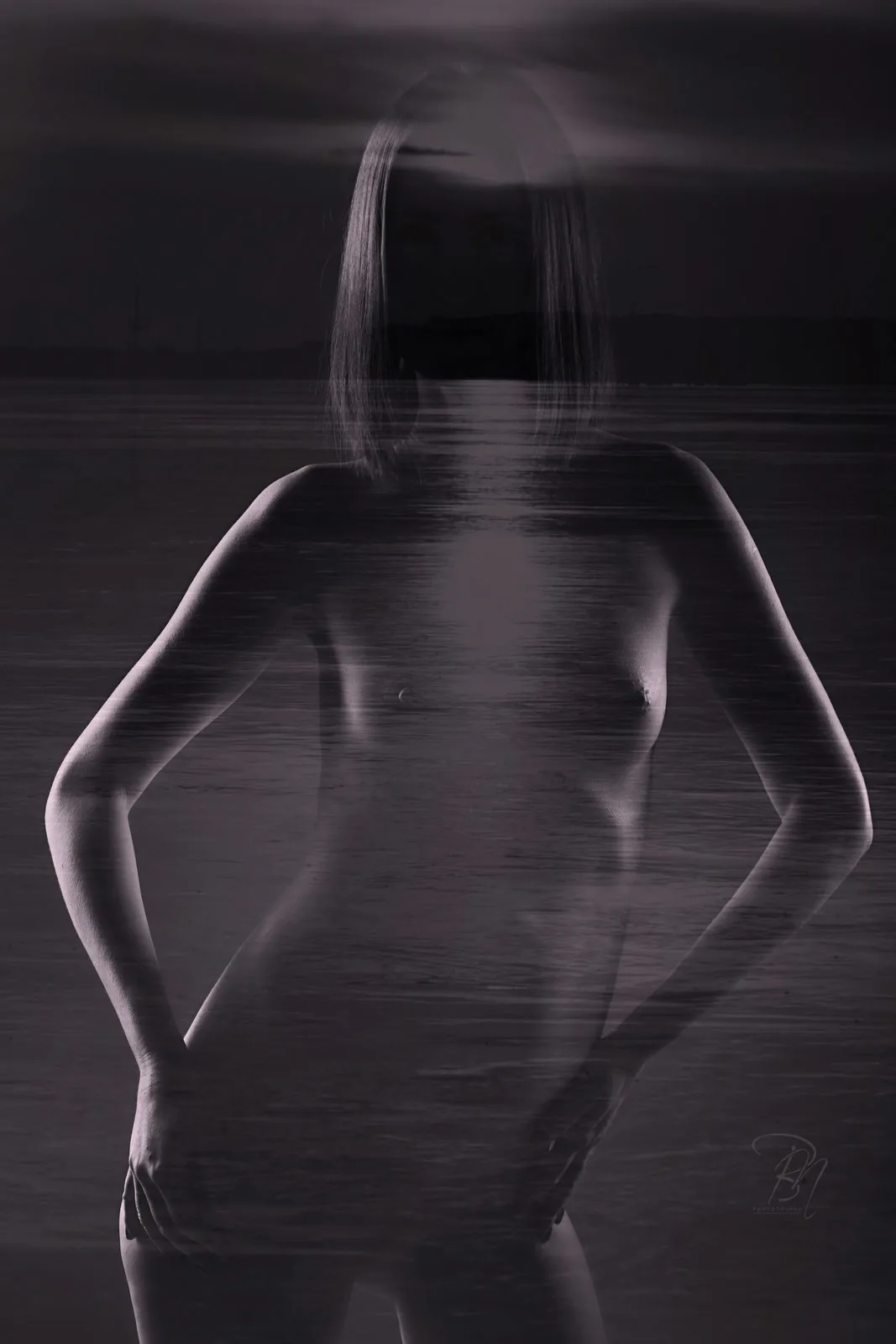 Blurred figure — Photo: Norbert Banhalmi A standing nude blurs into water and sky, the movement left visible.