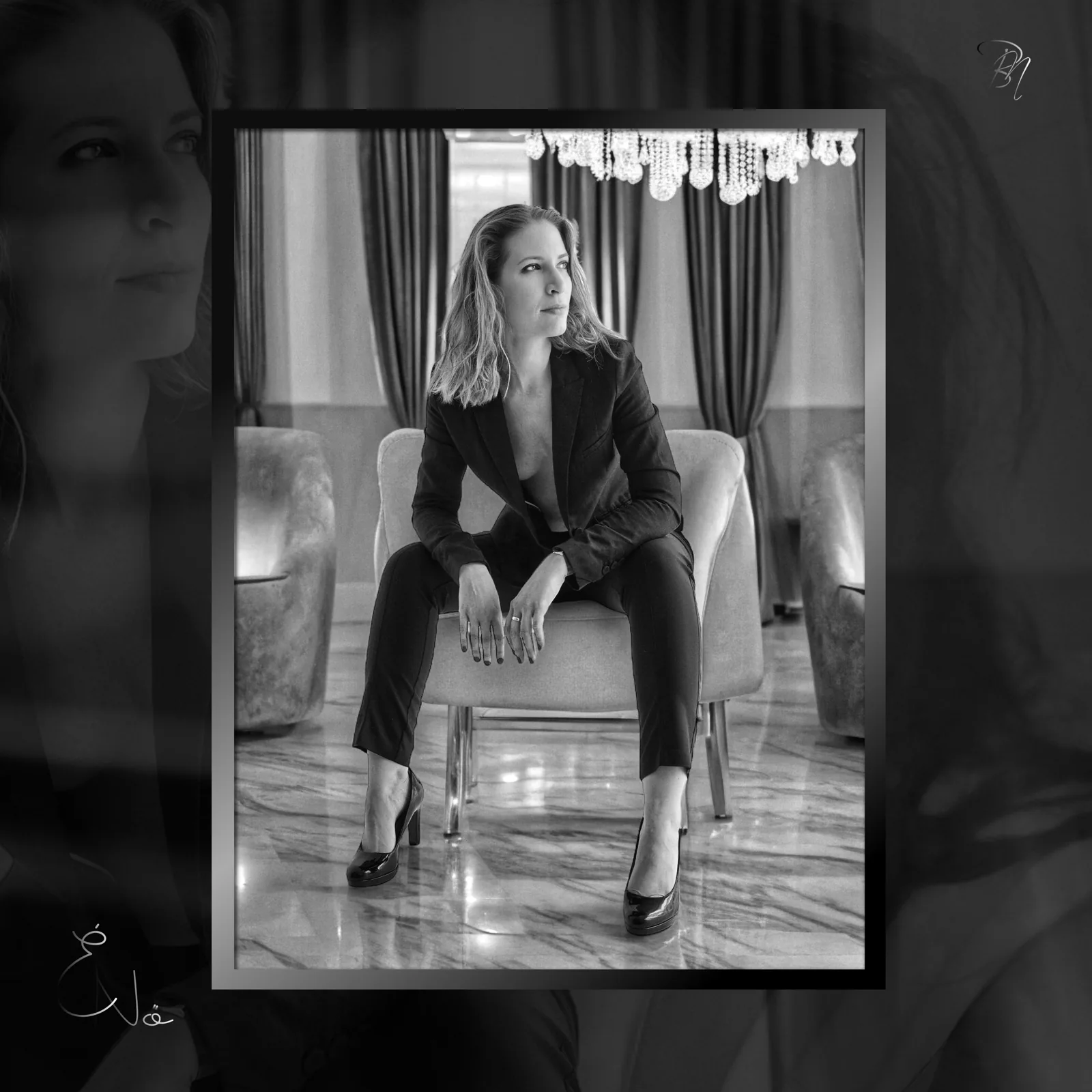 In the salon — Photo: Norbert Banhalmi A woman in a dark suit sits in an armchair in an elegant room.