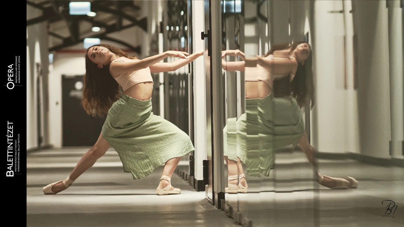 In the glass — Photo: Norbert Banhalmi A dancer bends backward beside a glass door, her reflection doubling the movement.