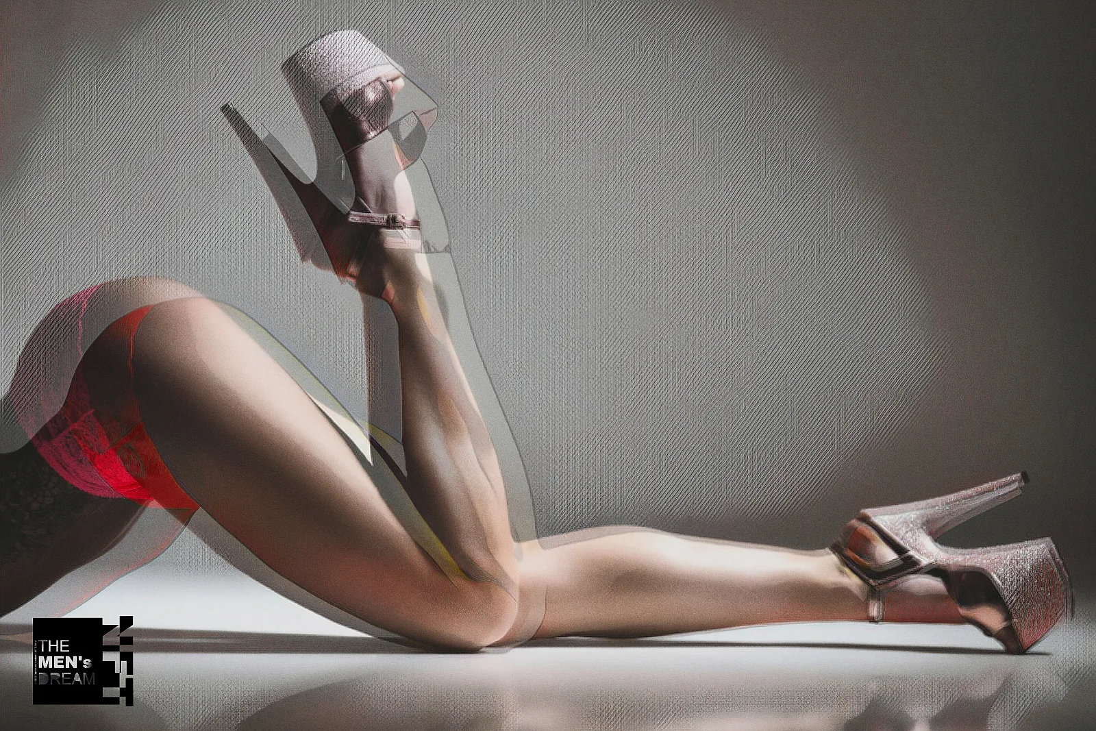 Legs and heels — Photo: Norbert Banhalmi Legs in high heels stretch across a plain grey studio wall.