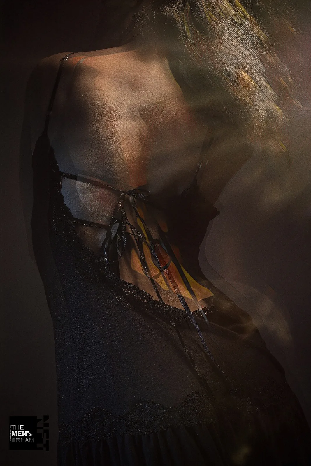Lace and gold — Photo: Norbert Banhalmi A back in lace, golden light blurring the edges of the frame.