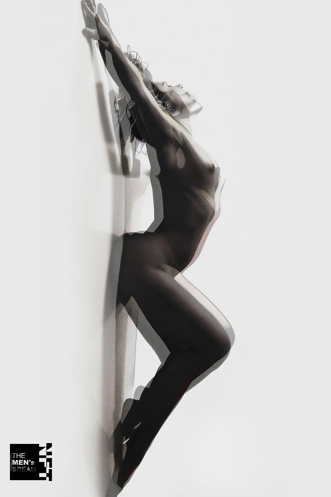 Against white — Photo: Norbert Banhalmi A figure stretches upward against a bright white wall, arms raised.